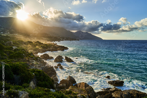 Sunlight illuminates water from rocky shores overlook