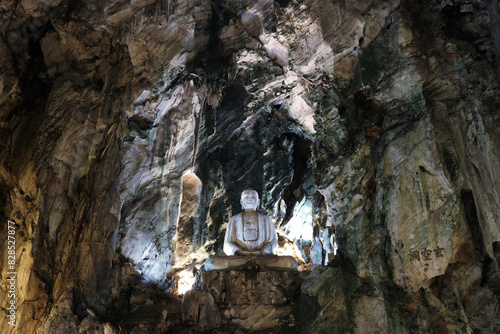 Buddha statue in Llinh Nham Cave Buddhist temple in Marble Mountains. Da Nang, Vietnam.
