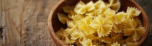 Wooden bowl filled with pasta on a table