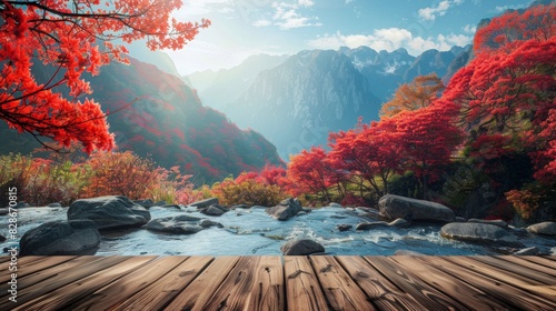 The foreground features an empty wooden tabletop overlooking a clear mountain stream. Across the stream is a Chinese mountain landscape, with the mountains densely covered in red azaleas