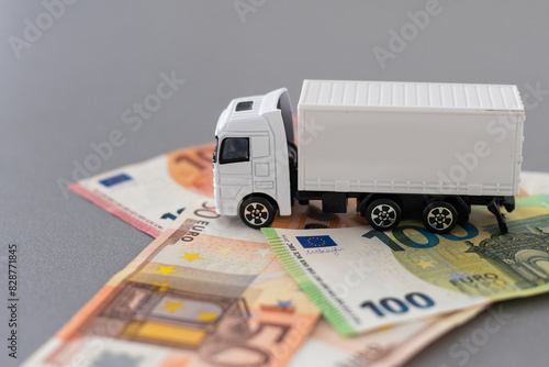 white toy truck on euro banknotes. concept for logistics, transportation and and finance