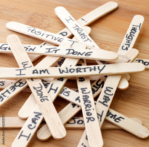 Positive Affirmations Written On Wooden Popsicle Sticks With Wooden Background