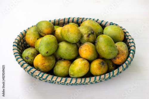 Fruit basket full of ripe mangoes. A wicker basket full of fresh ripe mangoes.