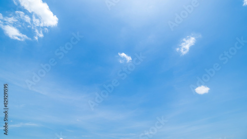 clear blue sky background,clouds with background, Blue sky background with tiny clouds. White fluffy clouds in the blue sky. Captivating stock photo featuring the mesmerizing beauty of the sky and cl