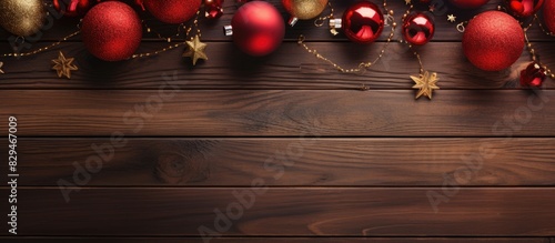 A close up copy space image of Christmas ornaments placed on a vibrant wooden background