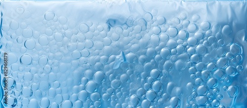 A copy space image of packaging with air bubbles on a blue background resembling bubble wrap texture and air bubble film
