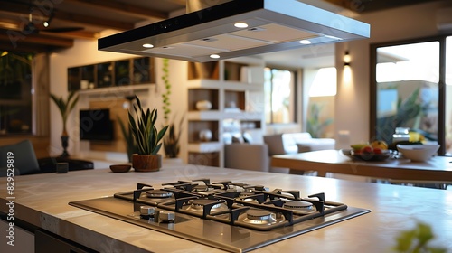 A modern open kitchen with a gas range on the island and a sleek range hood