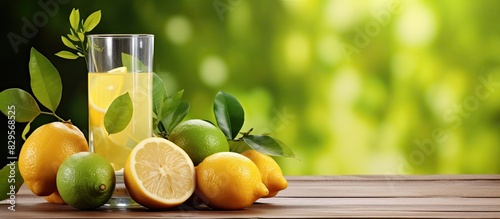 Limoncello and fresh citrus fruits on a wooden table with copy space image