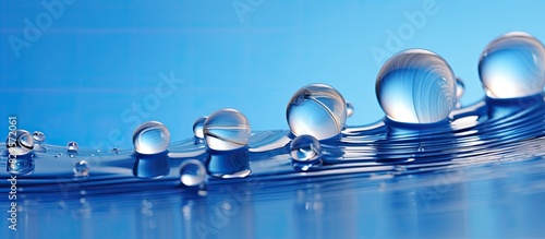 Blue background with water drops featuring shells in copy space image