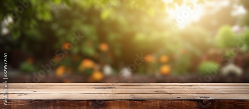 Wooden table featuring garden bokeh perfect for catering or food themes with a rural outdoor setting ideal for product displays with copy space image