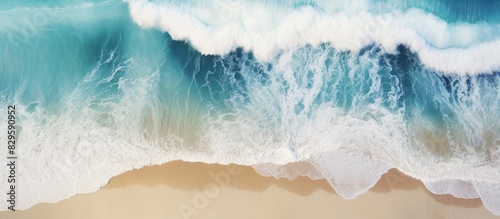 Aerial view of tropical beach surf with crashing waves showcasing an abstract ocean scene with copy space image