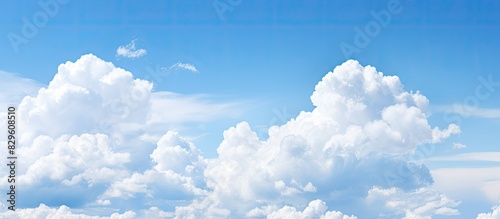 Lovely blue sky featuring fluffy white clouds against a bright and clear backdrop perfect for a copy space image