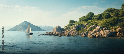 A boat is sailing near a rocky island by a coastal sea island providing a scenic composition in a stunning copy space image