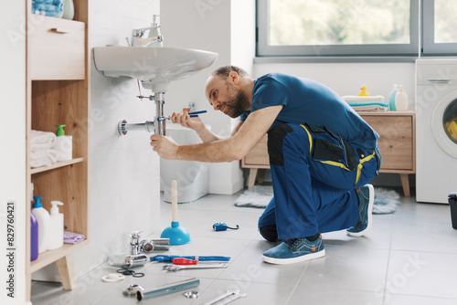 Professional plumber fixing a bathroom sink