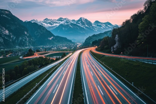 Light trails on the highway in the alps at sunset, europe travel and adventure through scenic mountain roads