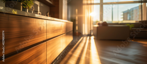 sunlight shining through a window onto a wooden dresser in a living room