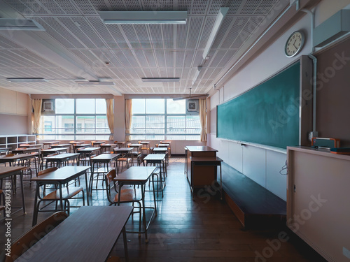 Typical Japanese classroom with desks and chairs, a platform, and a blackboard.