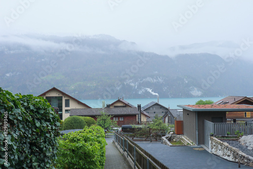 Brienz town on Lake Brienz by Interlaken, Switzerland, with snow covered Alps mountains in background
