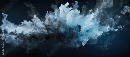An abstract image capturing the frozen motion of black powder exploding or being thrown against a backdrop with empty space around it. with copy space image. Place for adding text or design