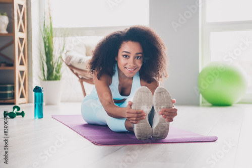 Full length photo of attractive slim lady activewear enjoying stretching back indoors room home house