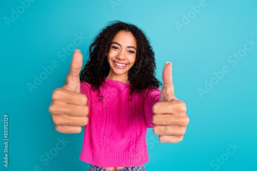 Photo of lovely young girl show thumb up wear pink pullover isolated on teal color background