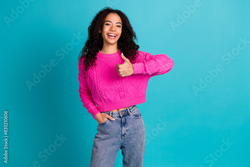 Portrait of nice young girl show thumb up empty space wear pink pullover isolated on turquoise color background
