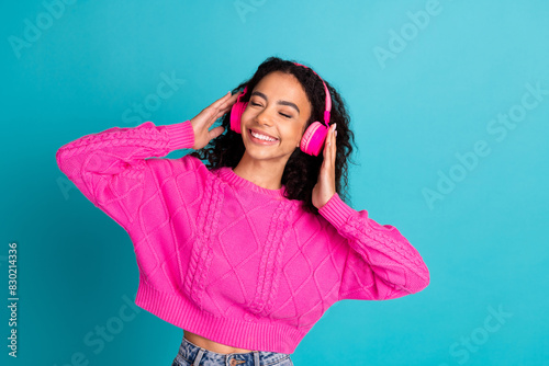 Photo portrait of attractive teen girl headphones enjoy music dressed stylish pink clothes isolated on aquamarine color background