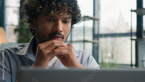 Pensive thoughtful Indian Arabian man male business person puzzled ethnic businessman employer think ideas deep thoughts search answer difficult question solve issue doubt analysis thinking at office