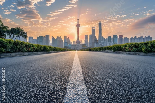 Straight asphalt road and modern city skyline with buildings in Guangzhou at sunset China. 
