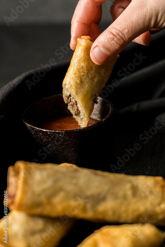 delicious spring rolls on a black plate