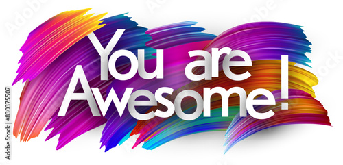 You are awesome paper word sign with colorful spectrum paint brush strokes over white.