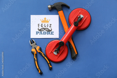 Tools and greeting card with text FELIZ DIA DEL PADRE on blue background