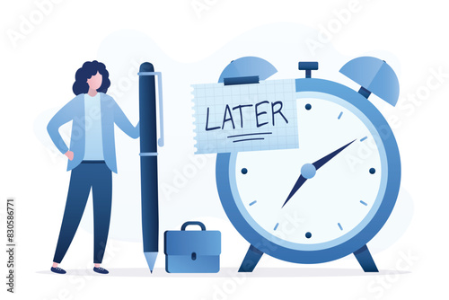 Businesswoman writing the word LATER on paper note attached to giant alarm clock. Later, postponing work or delaying deadlines, meeting schedule reminders. Time management.