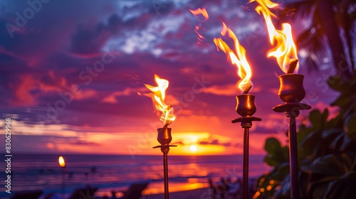 Hawaii sunset with fire torches. Hawaiian icon lights burning at dusk at beach resort or restaurants for outdoor lighting and decoration cozy atmosphere