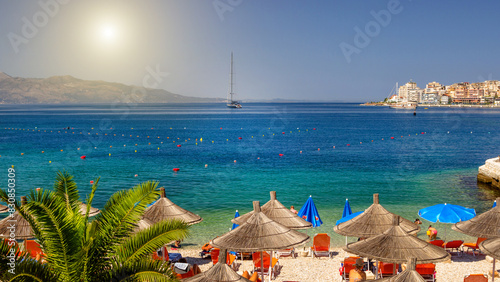 Beautiful beach with umbrellas for a holiday in Albania. Ionian Sea