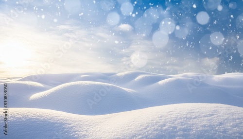  Winter snow background with snowdrifts, with beautiful light and snow flakes on the blue sky