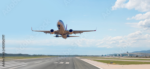 White Passenger plane fly up over take-off runway from airport - Barcelona, Spain