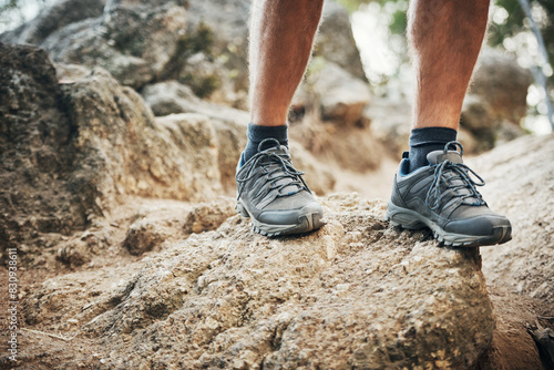 Legs, rocks and hiking shoes outdoors for fitness with health in mountain nature for exploration. Adventure, sneakers and feet for climbing with active person for expedition on cliff in America