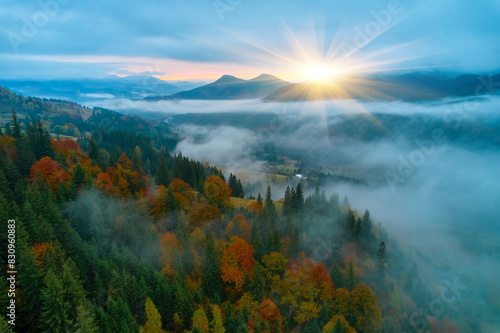 Flight over fog in Ukrainian Carpathians in summer. A thick layer of fog covers the mountains with a continuous carpet. Aerial drone view.
