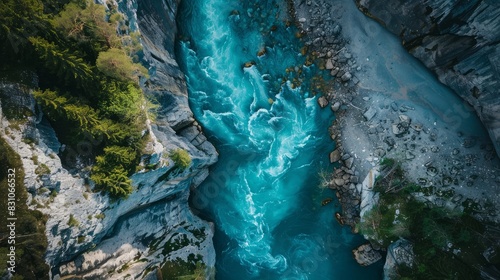 A vertical aerial view showcasing the surface of a flowing mountain river