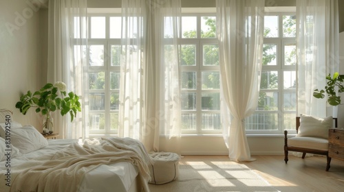 Bright and airy bedroom with large windows, sheer curtains, and a fresh color palette, maximizing natural light and space
