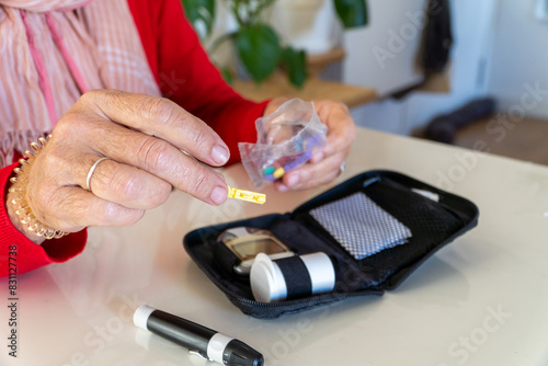 Senior woman handling sterile lancets to test sugar on blood