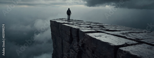 Challenges ahead, abyss cliff edge with gray clouds, symbolizing the journey towards success and overcoming obstacles.