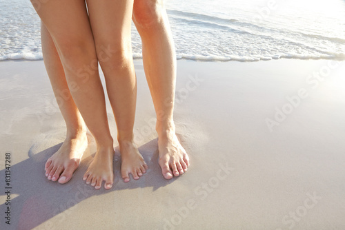 Family, beach and kid with toes in sand on vacation in nature with water, sea and summer travel. Waves, closeup and parent with feet of child on holiday to Maldives for outdoors, relax or sun for fun