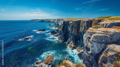 A picturesque coastal cliffside with rugged rock formations and a deep blue ocean crashing against the shore, under a clear, bright blue sky. 32k, full ultra hd, high resolution