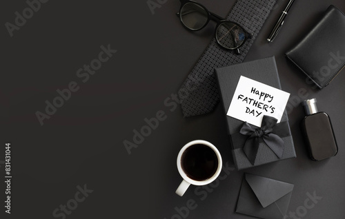 Fathers day background with gift box, necktie, glasses on black. Happy Fathers Day greeting card design.