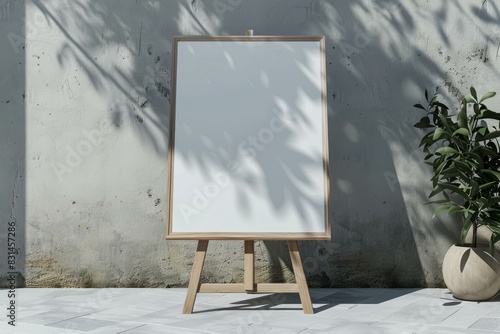 Empty easel board stands against a textured wall with plant shadows, ideal for mockups