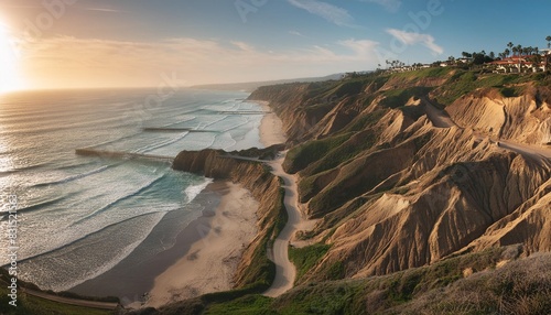 steep eroded cliffs with a zigzag path to black s beach california scripps pier and la jolla cove in the distance