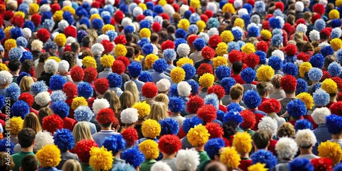 A sea of empty seats covered in team colors and pom poms, creating a lively and spirited atmosphere for cheering fans