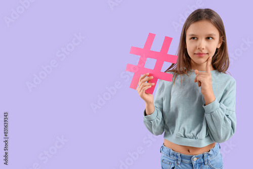 Thoughtful teenage girl with hashtag on lilac background